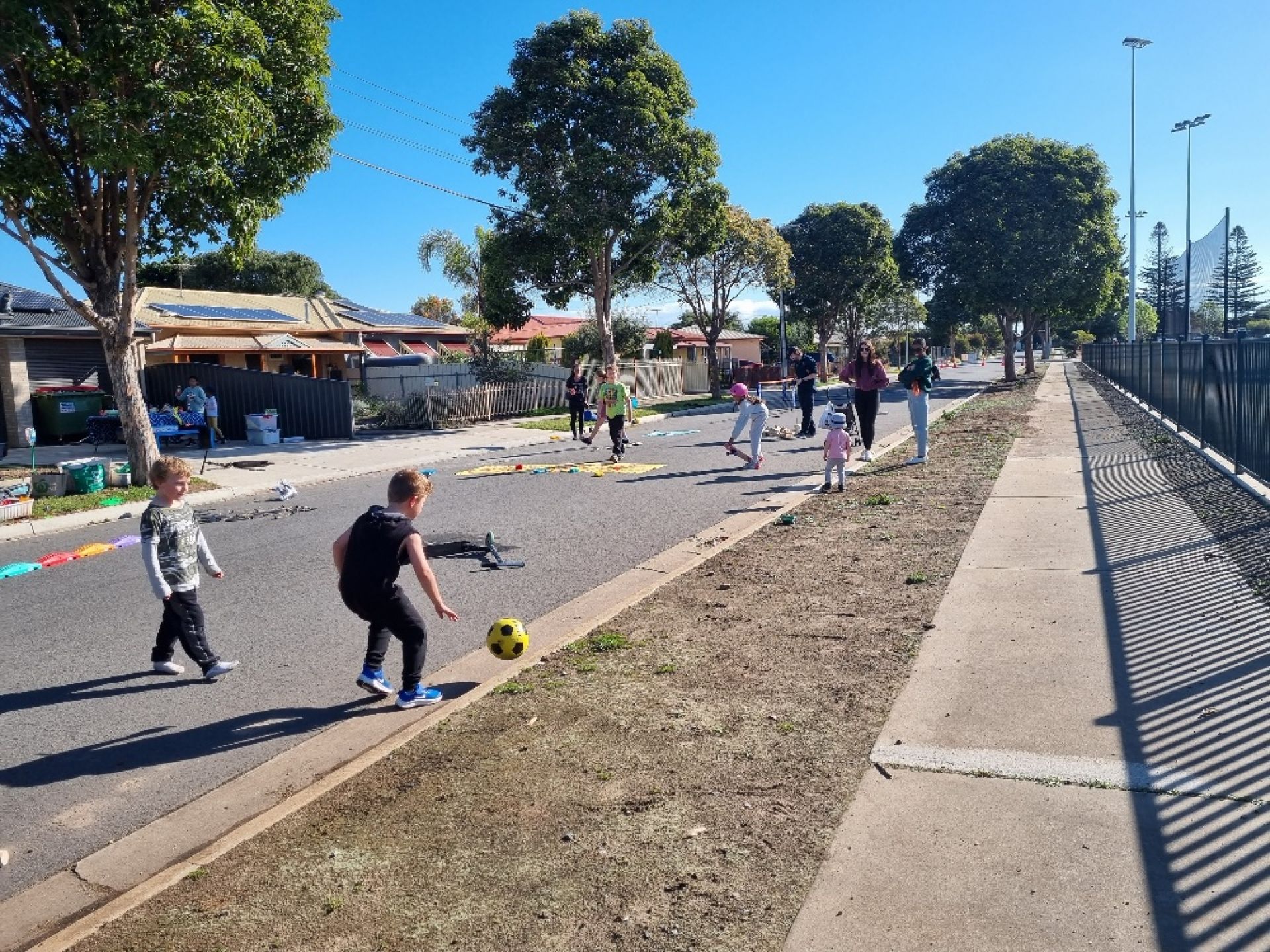 Children playing soccer on the street