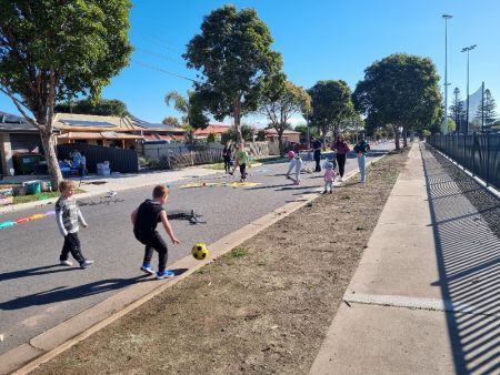 Children playing soccer on the street