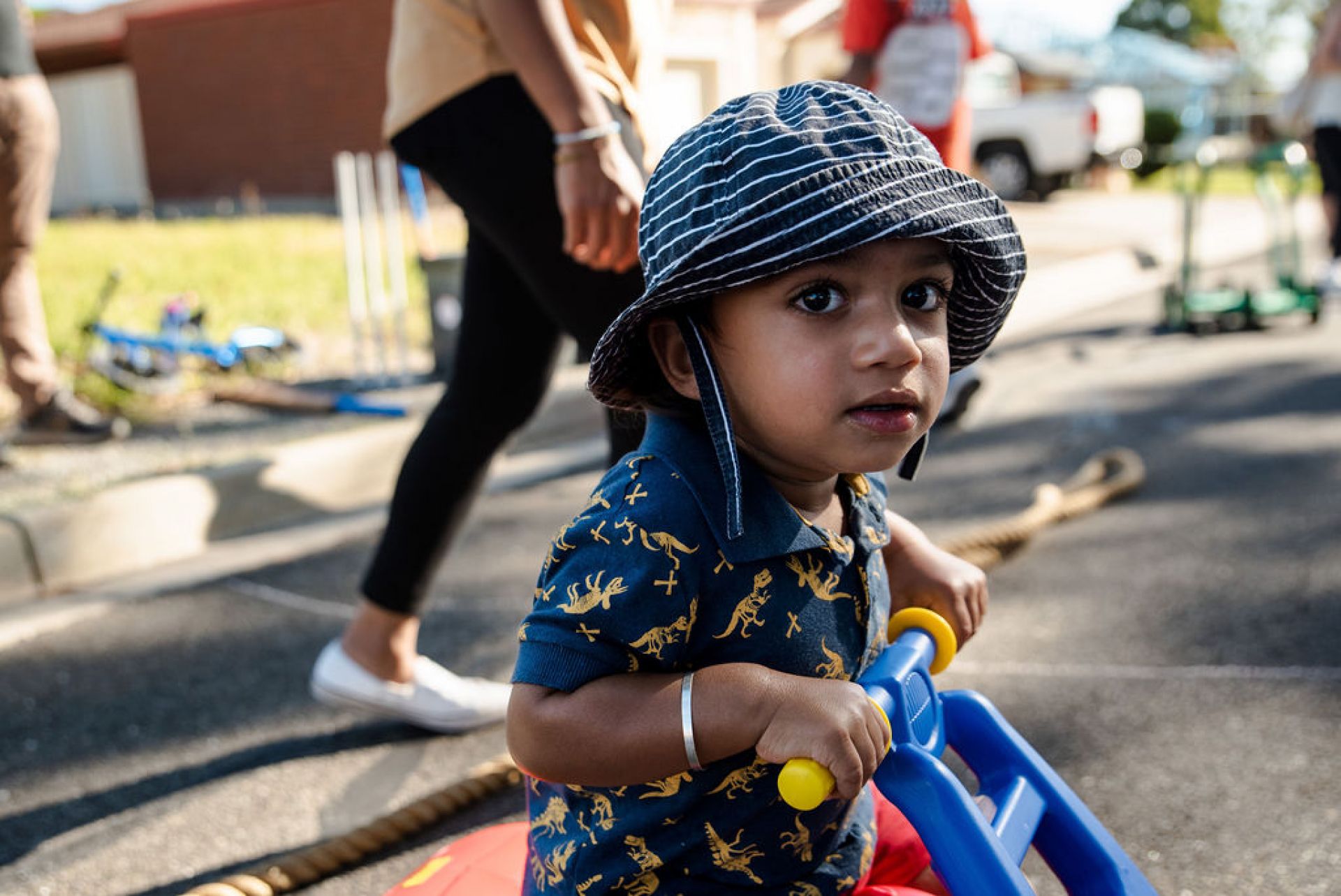 Little boy on trike, riding at a play street event