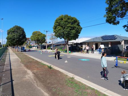 General image of children playing on a empty street.