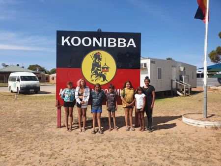 Youths standing in front of Koonibba Sign