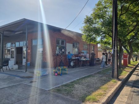 Community centre with stalls out the front, along the street