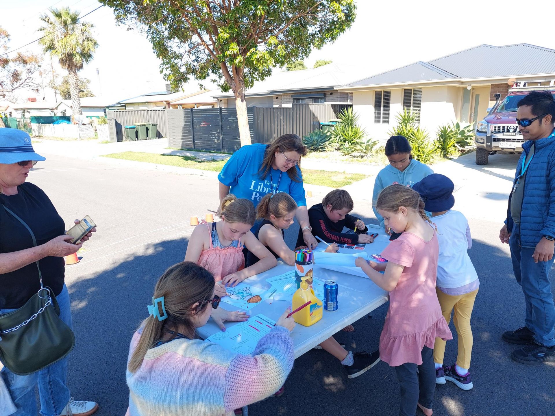 Children working at a trestle table on the street