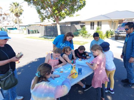 Children working at a trestle table on the street
