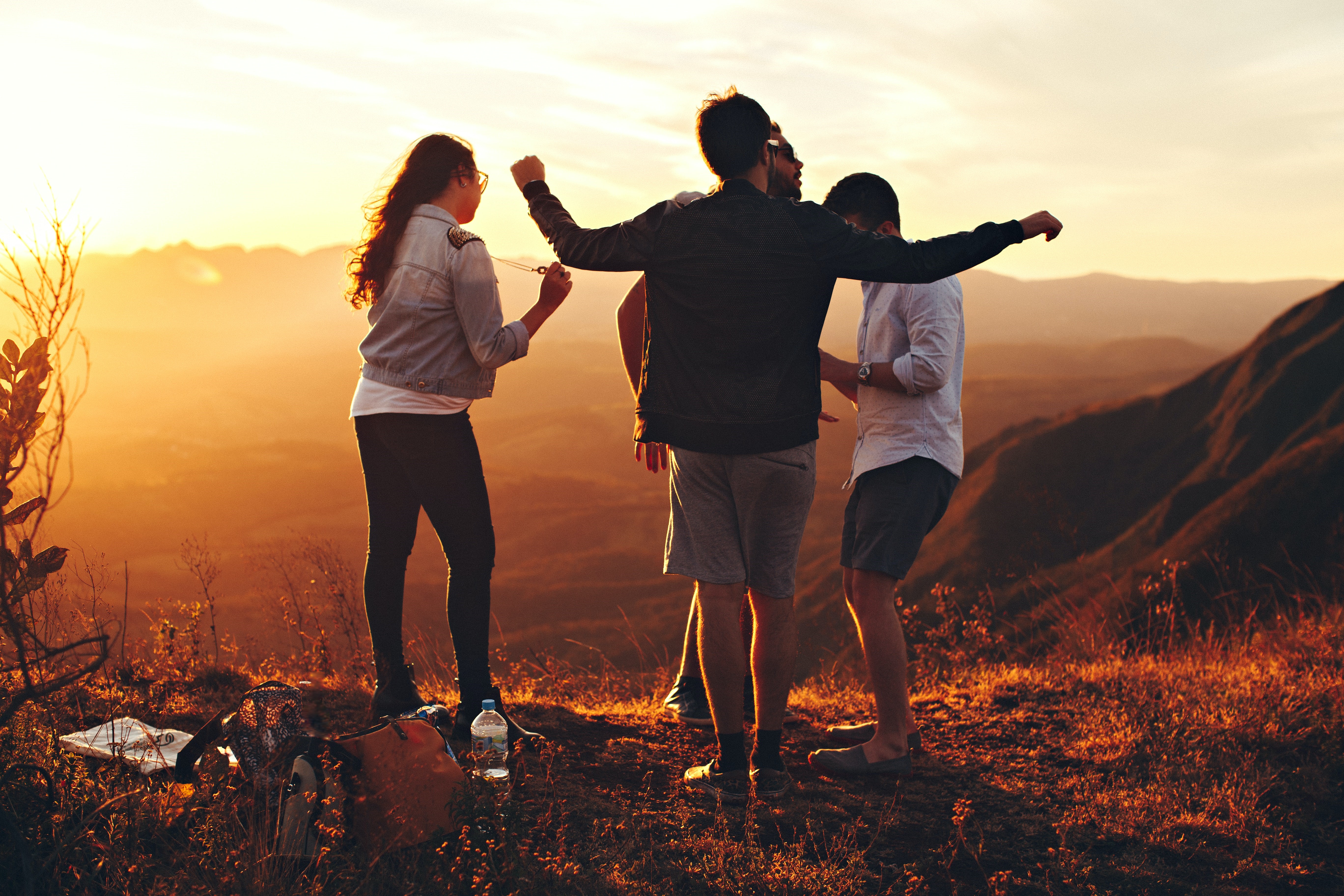 Youth on a hill top in the sunset